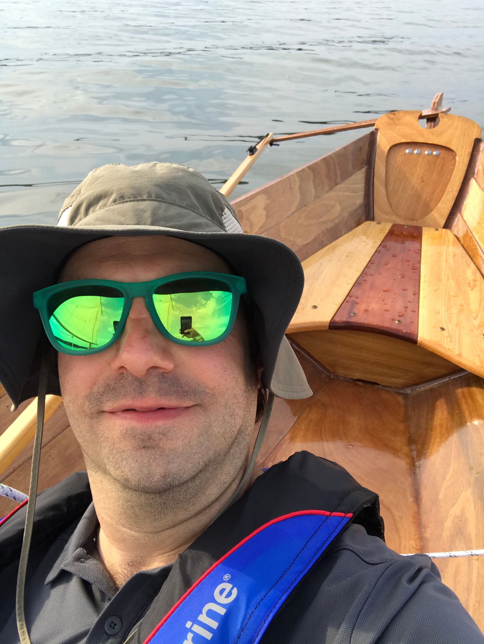 Selfie of the skipper In his new hat and the stern of the boat